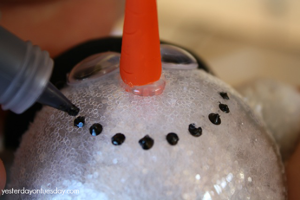 Create a Sparkly Snowman Ornament to hang on your Christmas tree from http://yesterdayontuesday.com/staging