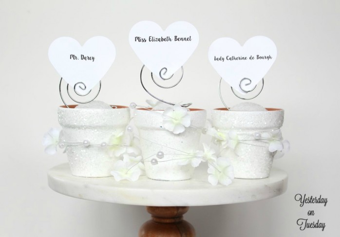 Whip up some elegant and inexpensive wedding place card holders out of mini flower pots!